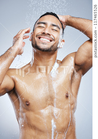 Man, shower and soap with water on body for cleaning, skincare and wash on white studio background. Male person, foam and hygiene with clear liquid for health, wellness and self care in bathroom 117465526