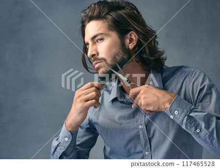 Scissors, wellness and man trimming beard on face for beauty routine, grooming and cosmetic hygiene on grey studio background. Barber, skincare and model cutting facial hair for clean style with comb Scissors, wellness and man trimming beard on face for beauty routine, grooming and cosmetic hygiene on grey studio background. Barber, skincare and model cutting facial hair for clean style with comb 117465528