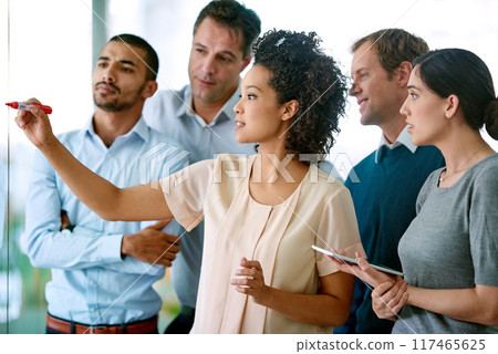 Business people, writing and coaching with tablet on glass board for schedule planning, tasks or agenda at office. Group of creative employees taking notes for discussion, brainstorming or startup 117465625