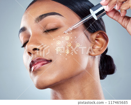 Indian woman, skincare and serum with dropper for beauty, product and hydration on studio background. Dermatology overlay, cosmetics and wellness for hyaluronic acid, vitamin a or collagen facial 117465685