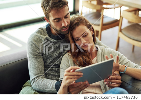 Couple, hug and tablet on sofa for streaming subscription, movie selection or tv decision at home. Smile, man and woman with technology and web search on couch for bonding, scroll and show discussion 117465736