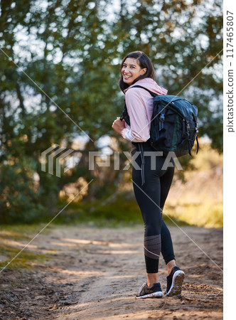 Woman, portrait and hiking in nature for health, backpack and outdoor fitness or exercise on path. Female person, trekking and bag for mountain adventure, cardio and walking in forest for workout Woman, portrait and hiking in nature for health, backpack and outdoor fitness or exercise on path. Female person, trekking and bag for mountain adventure, cardio and walking in forest for workout 117465807