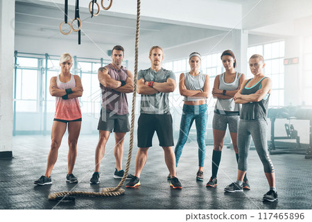 Rope, portrait and group of athletes in gym for health, wellness and body workout challenge. Fitness class, friends and team of people with personal trainer for exercise together in sports center. 117465896
