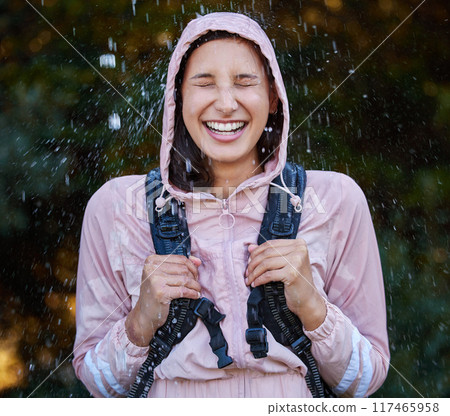 Rain, laugh and happy woman with backpack in a forest for travel, adventure and discovery in nature. Water splash, freedom and excited explorer backpacking in woods with energy, storm and celebration Rain, laugh and happy woman with backpack in a forest for travel, adventure and discovery in nature. Water splash, freedom and excited explorer backpacking in woods with energy, storm and celebration 117465958