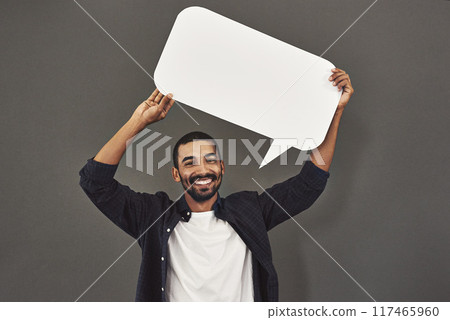 Man, marketing and speech bubble in studio with mockup for advertising, social media and information. Male person, icon and poster with smile for review, opinion and billboard on gray background 117465960