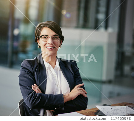 Woman, architect and portrait in office with plans, blueprints and confident at desk. Female engineer, smile and proud in architecture firm for construction project, design and paperwork at table 117465978