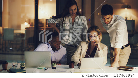 Business team, online and night in office with laptop for deadline of project, strategy session and commitment for task. Corporate, employees and working late for overtime, internet and research. 117465984