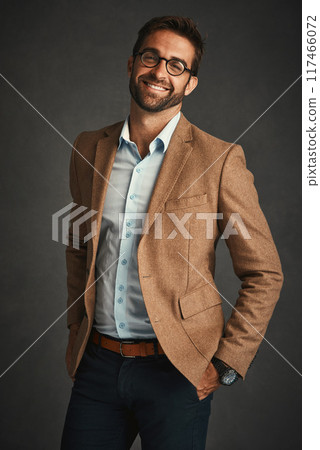 Man, smile and fashion for confident in studio with stylish, trendy and smart luxury clothes as Professor. Pride, male person and portrait for wealth, designer glasses or elegant on grey background 117466072