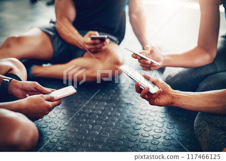 People, hands and calendar with phone for fitness schedule, workout or data sync at gym. Closeup of group on mobile smartphone or networking for training day, exercise routine or date at health club People, hands and calendar with phone for fitness schedule, workout or data sync at gym. Closeup of group on mobile smartphone or networking for training day, exercise routine or date at health club 117466125