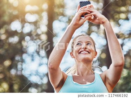 Woman, nature and runner or exercise selfie, workout app and training in woods for fitness routine. Female person, cardio website and athlete for wellness or exercise, forest path and social media 117466192