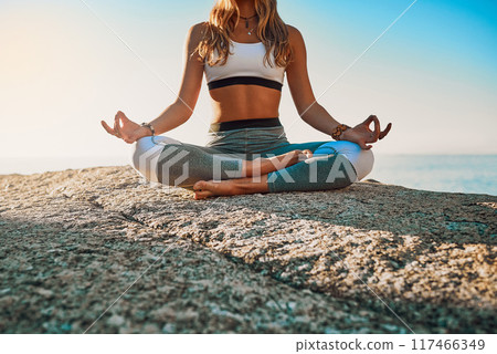 Beach, meditation and woman with chakra for yoga, wellness and spiritual peace in California. Zen, female yogi and hands with lotus pose for calm, relaxing and mental health by rock outdoors 117466349