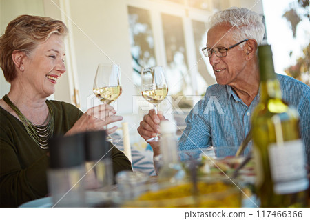 Love, celebration and senior couple with wine toast on patio for anniversary, event or birthday party brunch. Food, happy and old people at an outdoor restaurant with retirement, cheers or bonding 117466366