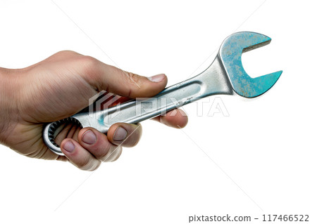 Hand holding a spanner isolated on white background 117466522