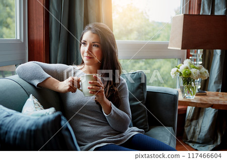 Thinking, peace or happy woman in home with coffee to relax, chill and enjoy beverage on sofa in England. Remember, drink or calm girl on break for tea, caffeine or cappuccino for nostalgia or memory 117466604