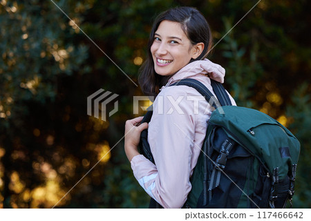 Hiking, portrait and happy woman with backpack in forest for adventure, explore and trekking journey in nature. Park, face and girl camper smile in woods for freedom, travel and campsite discovery 117466642