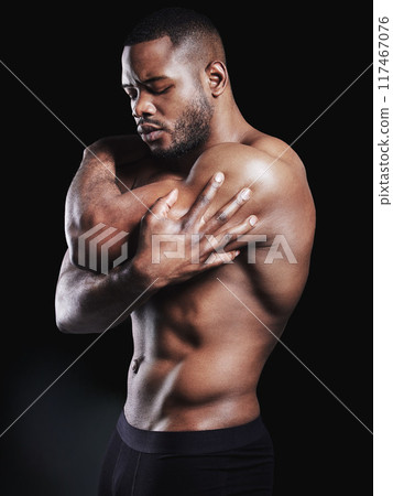 Thinking, stretching and black man with pride for fitness, health and body care in studio. African athlete, bodybuilder and muscles or biceps by dark background for wellness, training and results 117467076