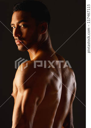 Back, fitness and portrait of man with muscles in studio for workout, sports and wellness or training. Bodybuilder, athlete and male person for progress and results by black background with pride Back, fitness and portrait of man with muscles in studio for workout, sports and wellness or training. Bodybuilder, athlete and male person for progress and results by black background with pride 117467115