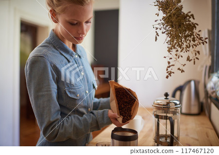 Woman, coffee beans and grinder in kitchen for drink preparation with plunger for morning, caffeine or latte. Home, brown bag and pour in machine on counter for hot beverage, matcha or cappuccino Woman, coffee beans and grinder in kitchen for drink preparation with plunger for morning, caffeine or latte. Home, brown bag and pour in machine on counter for hot beverage, matcha or cappuccino 117467120