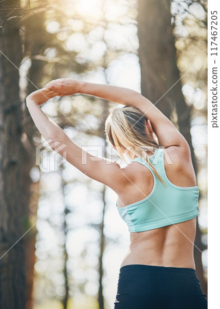 Woman, woods and stretching arms for warm up, runner and training for fitness routine or exercise. Female person, back and flexibility for muscle or athlete for wellness, forest path and prepare 117467205
