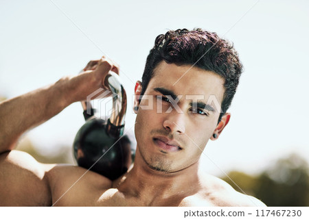 Portrait, outdoor and man with kettlebell, exercise and fitness for wellness, balance and strong. Face, healthy person and guy with equipment, challenge or workout with training, cardio and endurance Portrait, outdoor and man with kettlebell, exercise and fitness for wellness, balance and strong. Face, healthy person and guy with equipment, challenge or workout with training, cardio and endurance 117467230