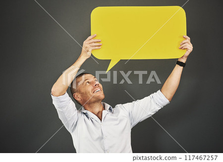 Man, social media and speech bubble in studio for advertising, marketing and information with smile. Male person, icon and poster with mockup space for review, opinion or billboard on gray background Man, social media and speech bubble in studio for advertising, marketing and information with smile. Male person, icon and poster with mockup space for review, opinion or billboard on gray background 117467257