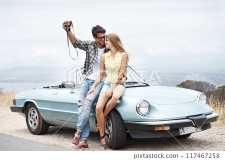 Road trip, travel and couple in convertible in nature for freedom, vacation and happiness together. Summer, selfie and man with woman, smile and romance on drive in mountain countryside for transport Road trip, travel and couple in convertible in nature for freedom, vacation and happiness together. Summer, selfie and man with woman, smile and romance on drive in mountain countryside for transport 117467258
