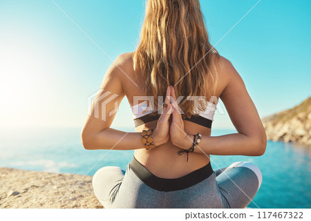 Beach, prayer hands and back of woman for yoga, wellness and spiritual peace in California. Chakra, female yogi and namaste with meditation for wellbeing, relaxing and mental health by ocean outdoor 117467322