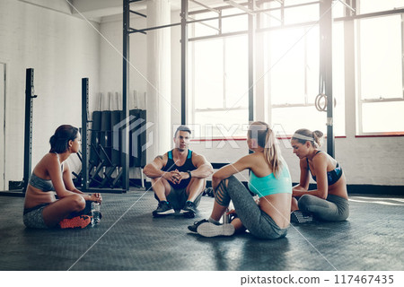 People, fitness and discussion with team for meeting, workout routine or social on gym floor. Active group in conversation, rest or break after indoor training or exercise together at health club People, fitness and discussion with team for meeting, workout routine or social on gym floor. Active group in conversation, rest or break after indoor training or exercise together at health club 117467435