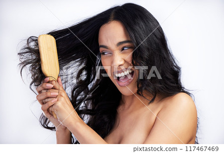 Woman, angry and brush in studio for grooming, cleaning and tangled on white background. Female person, cosmetics and tool for self care in routine, frustrated and damaged textures for treatment Woman, angry and brush in studio for grooming, cleaning and tangled on white background. Female person, cosmetics and tool for self care in routine, frustrated and damaged textures for treatment 117467469