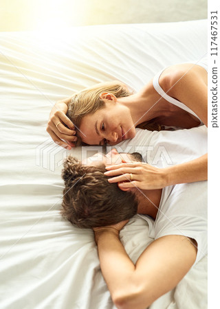 Couple, care and relax with hug on bed in morning, embrace or support for marriage commitment at house. Love, woman and man with hug for quality relationship, romance or together on anniversary 117467531