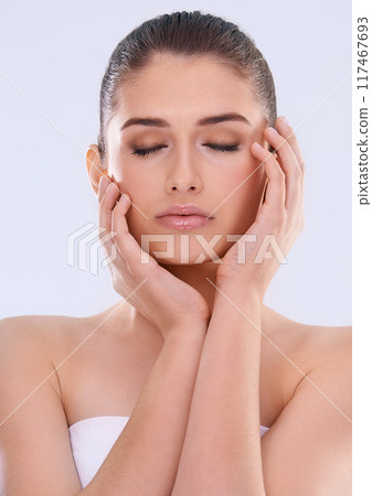 Woman, eyes closed and hands on face for beauty, glow and wellness with dermatology for skin on white background. Natural cosmetics, skincare and calm with self care, shine and facial in studio Woman, eyes closed and hands on face for beauty, glow and wellness with dermatology for skin on white background. Natural cosmetics, skincare and calm with self care, shine and facial in studio 117467693