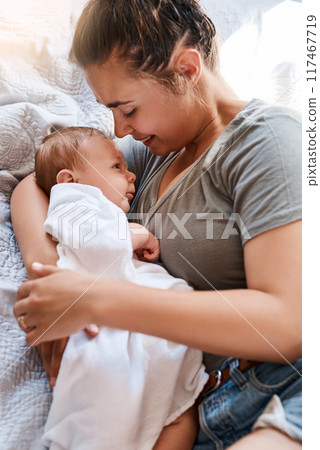 Mom, newborn and happy on bed in home for support, love and care for growth and child development. Parent, kid and smile in bedroom with trust for bonding, childhood memories and toddler 117467719