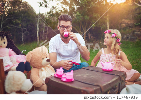 Father, tea party and girl child in garden for nature picnic with toys, teddy bear and suitcase for table. Daughter, dad and memory together for playing or entertainment, bonding and love in outdoor Father, tea party and girl child in garden for nature picnic with toys, teddy bear and suitcase for table. Daughter, dad and memory together for playing or entertainment, bonding and love in outdoor 117467939