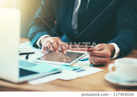 Businessman, hands and credit card for finance on tablet in office for payment, digital purchase or banking investment. Financial employee, fintech and stock market trading with startup loan at desk 117468026