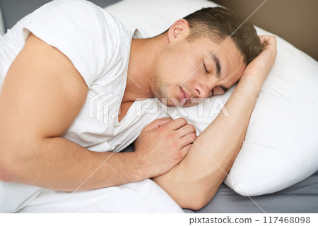 Sleeping, man and bedroom in the morning with nap, rest and dreaming in bed at hone. Relax, house and comfortable on pillow under a blanket with tired, fatigue and calm guy with linen duvet on break 117468098