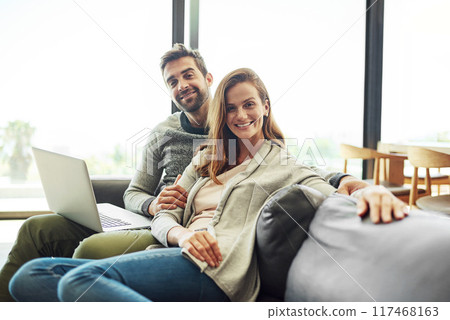 Portrait, smile and couple on laptop in living room for relax, support and connection for love together. Happy man, woman and computer in home for social media, news and streaming on website on sofa 117468163