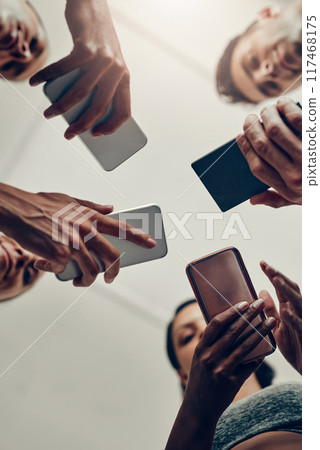 People, hands and below with phone for fitness schedule, workout or data sync at gym. Low angle, closeup or group on mobile smartphone for training day, exercise routine or networking at health club 117468175