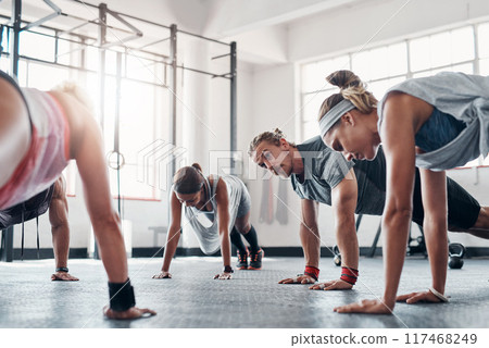Team, fitness class and exercise with push ups in gym for arm strength, healthy body and core workout. Training collaboration, people and muscle challenge for abs, weightloss and physical activity 117468249