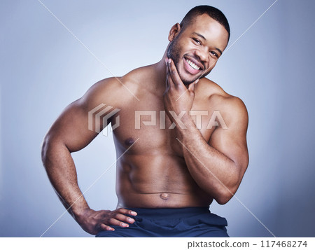 Black man, portrait or skincare in studio with cosmetics for smooth skin, facial treatment or morning routine. Model, person or topless with smile for wellness, selfcare or hygiene on blue background 117468274