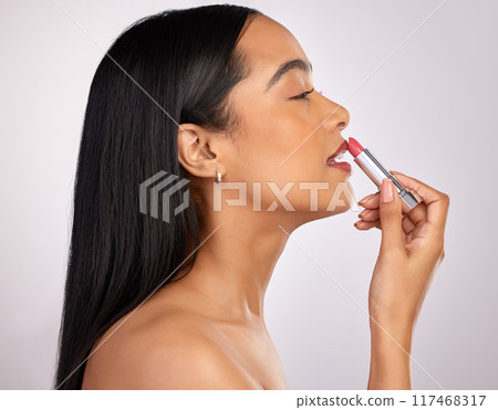 Profile, apply and woman in studio with lipstick for cosmetics, confidence or makeup on white background. Aesthetic, beauty product and hand of model for satisfaction, natural glow or salon treatment Profile, apply and woman in studio with lipstick for cosmetics, confidence or makeup on white background. Aesthetic, beauty product and hand of model for satisfaction, natural glow or salon treatment 117468317