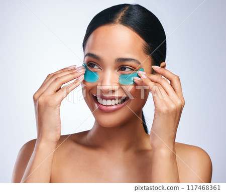 Woman, apply and eye patches in studio, facial treatment and hydration mask on white background. Female person, skincare and beauty product for antiaging, vitamin e and pads to pamper or cosmetics Woman, apply and eye patches in studio, facial treatment and hydration mask on white background. Female person, skincare and beauty product for antiaging, vitamin e and pads to pamper or cosmetics 117468361