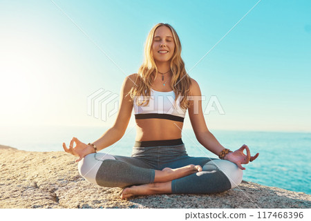 Outdoor, happy and woman with chakra for yoga, wellness and spiritual peace in California. Zen, female yogi and hands with lotus pose for meditation, relaxing and mental health on beach in nature 117468396