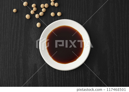 Black Japanese style background and soy sauce on a plate Black Japanese style background and soy sauce on a plate 117468501