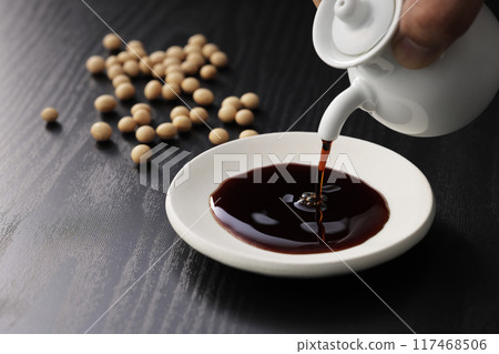 Black Japanese style background and soy sauce on a plate Black Japanese style background and soy sauce on a plate 117468506
