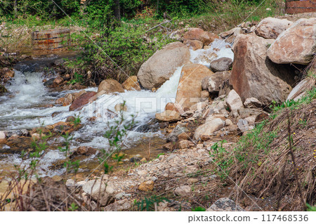 Fast mountain river running among large stones 117468536