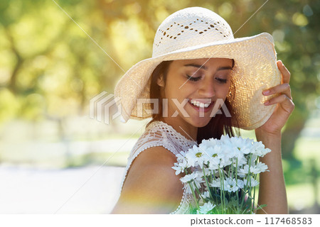 Woman, happy and flowers for relaxing in park or garden, smile and travel on summer holiday. Female person, peace and enjoy vacation in countryside, outdoors and hat on weekend adventure in nature Woman, happy and flowers for relaxing in park or garden, smile and travel on summer holiday. Female person, peace and enjoy vacation in countryside, outdoors and hat on weekend adventure in nature 117468583