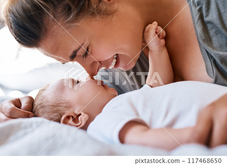 Mom, baby and happy on bed in home for support, love and care for growth and child development. Parent, kid and happy in bedroom with playing for bonding, childhood memories and smile with toddler 117468650