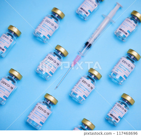 Medical, syringe and glass bottle of vaccine by blue background, treatment or illness prevention. Healthcare, medicine and injection for disease, coronavirus or covid 19 for immune wellness in studio Medical, syringe and glass bottle of vaccine by blue background, treatment or illness prevention. Healthcare, medicine and injection for disease, coronavirus or covid 19 for immune wellness in studio 117468696