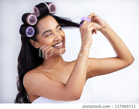 Woman, haircare and rollers in studio for textures, grooming and treatment for curly hairstyle. Female person, cosmetics and tool for waves in routine, white background and healthy locks for beauty Woman, haircare and rollers in studio for textures, grooming and treatment for curly hairstyle. Female person, cosmetics and tool for waves in routine, white background and healthy locks for beauty 117468711