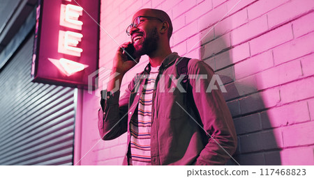 Happy man, conversation and neon light with phone at night for communication outside bar, pub or club. Male person talking with smile in happiness on mobile smartphone for friendly discussion in city Happy man, conversation and neon light with phone at night for communication outside bar, pub or club. Male person talking with smile in happiness on mobile smartphone for friendly discussion in city 117468823